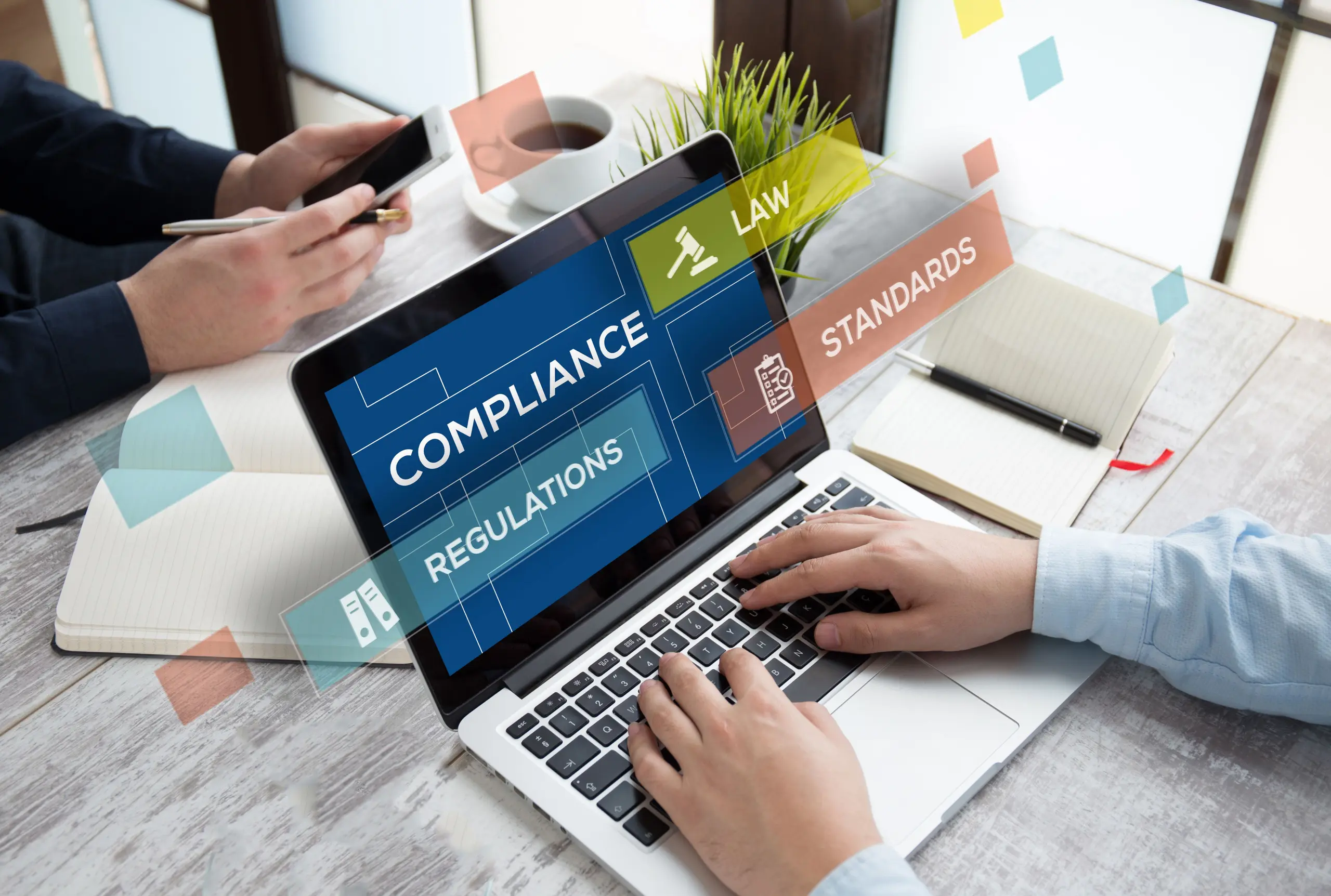 Person using laptop with compliance and regulations interface
