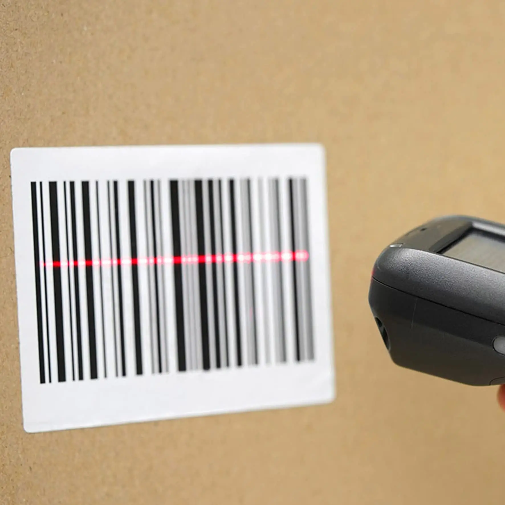 Barcode scanner pointing at shipping label