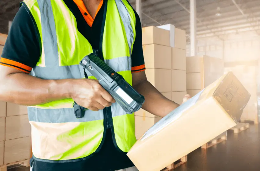 Worker scanning package in warehouse