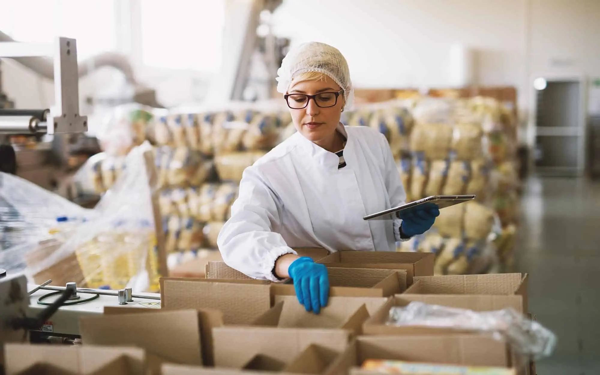 Food worker with clipboard in warehouse