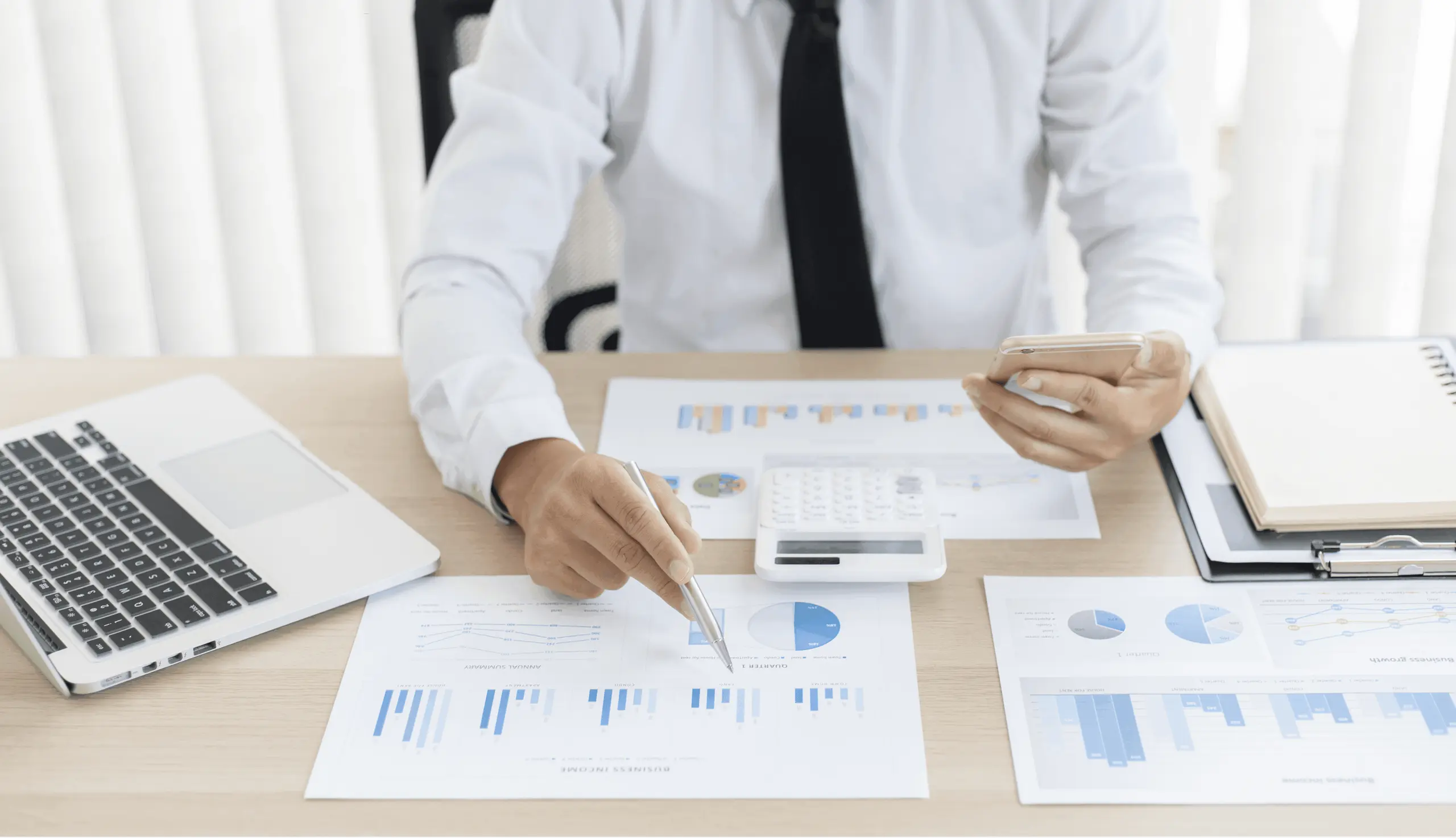Business person pointing at financial charts
