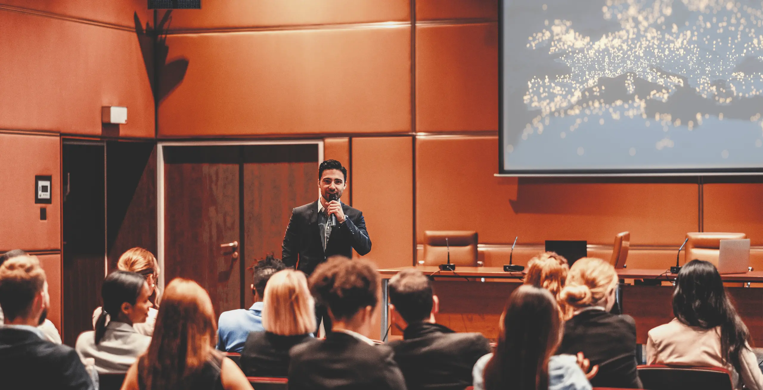 Speaker presenting to an audience in a conference room