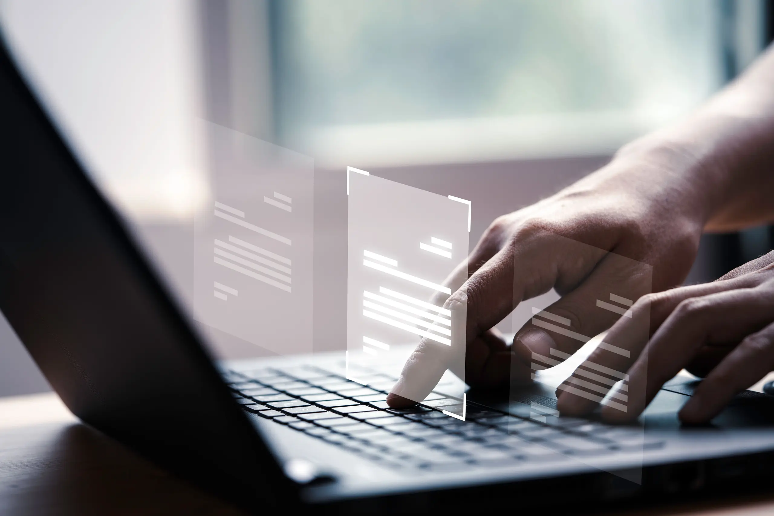 Hands typing on laptop keyboard